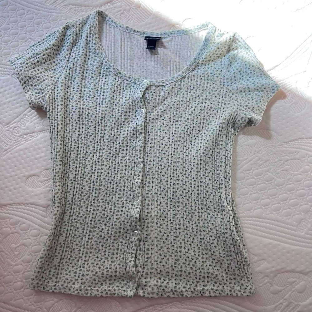 White button top with green floral pattern